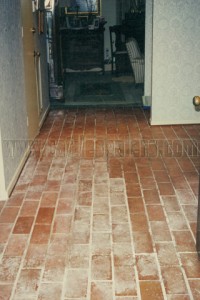 Interior brick floor with water damage from flood.
