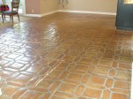 Mexican Saltillo paver tile with tape damage and heavy sealer build-up.